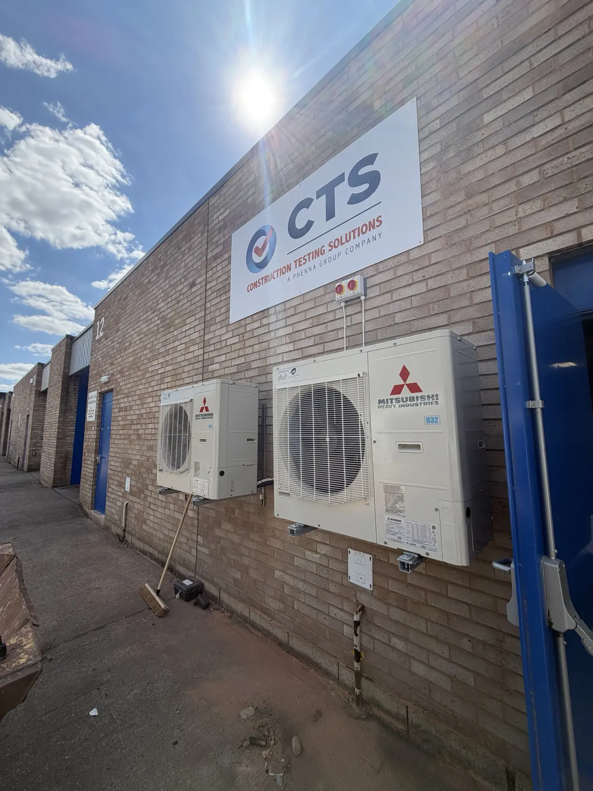Two Mitsubishi Heavy Industries outdoor units installed on a commercial unit