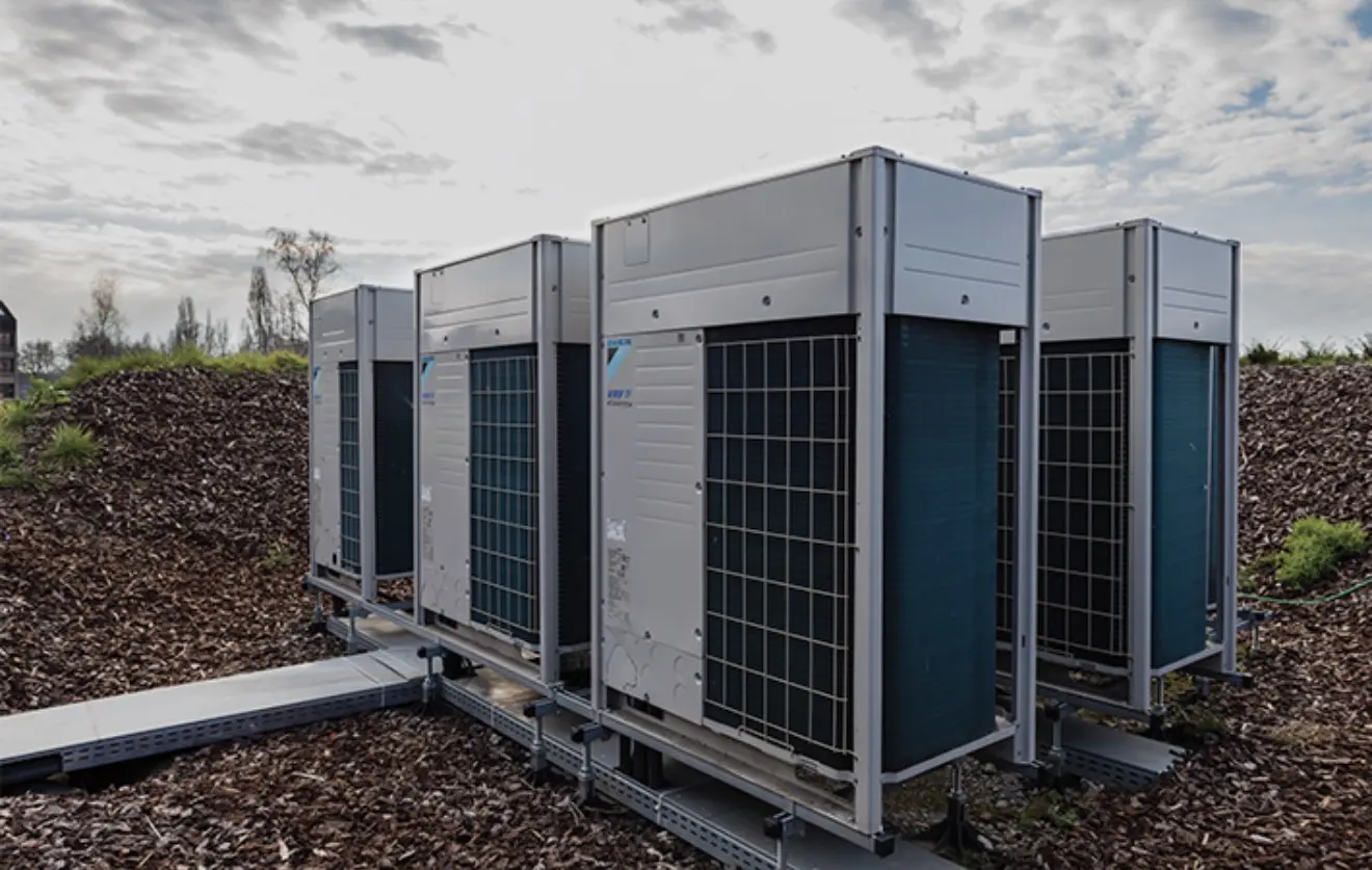 Daikin VRV outdoor units on a commercial roof, on a raised steel frame
