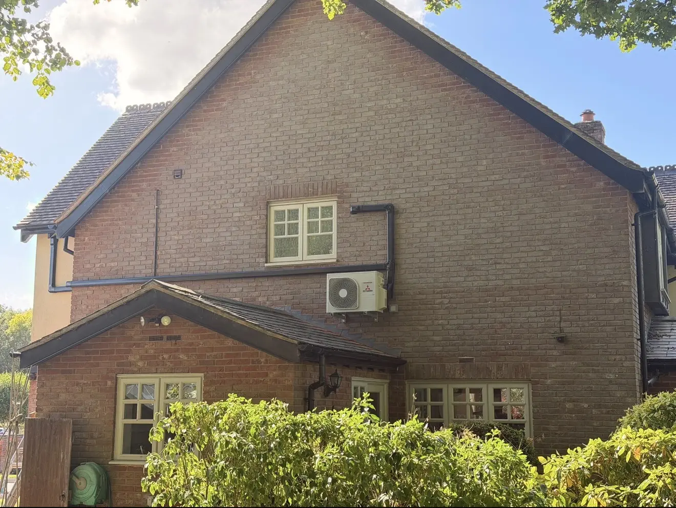 Domestic air conditioning installation on a brick house gable