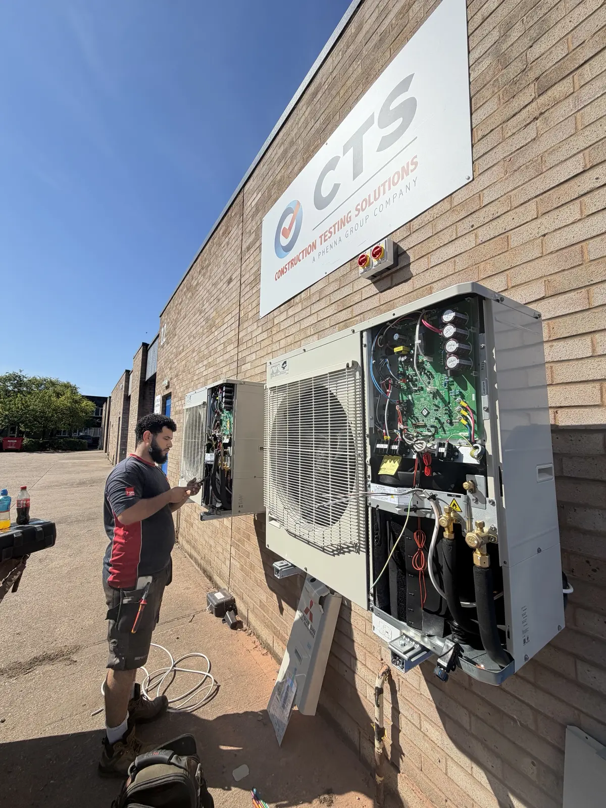 Engineer commissioning a commercial air conditioning outdoor unit