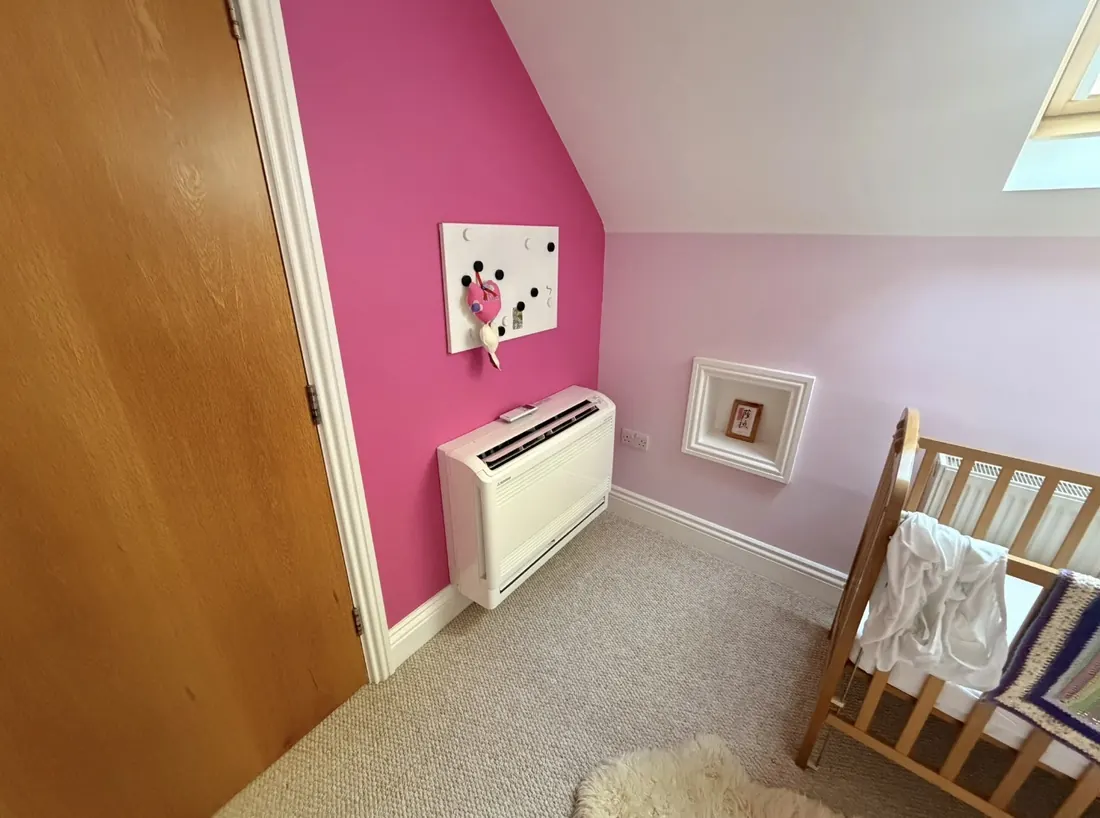 Floor-standing Mitsubishi unit fitted low on the wall of a child’s bedroom