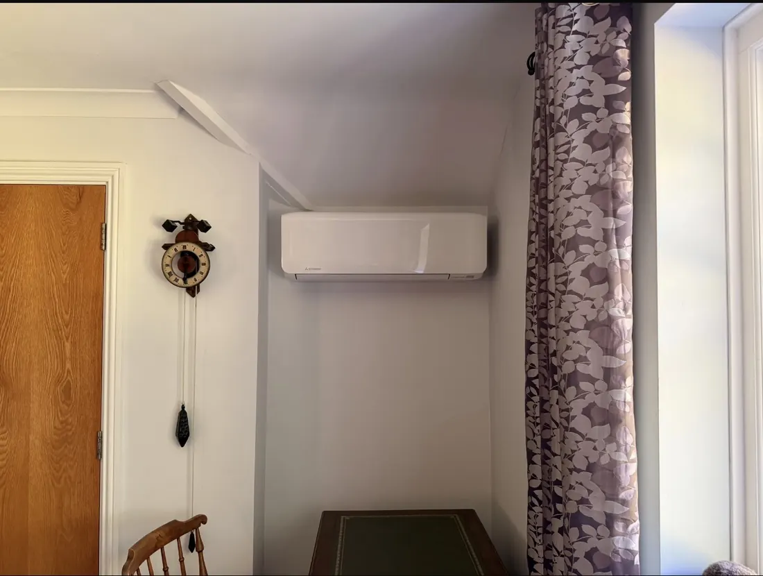 Mitsubishi wall unit fitted neatly in a sloping-ceiling corner of a living room