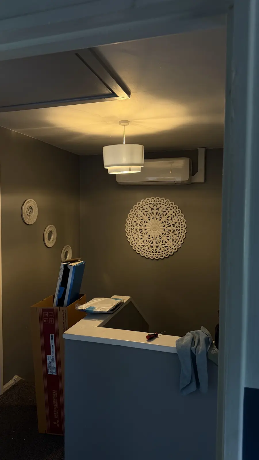 Wall-mounted air conditioning unit installed on a landing