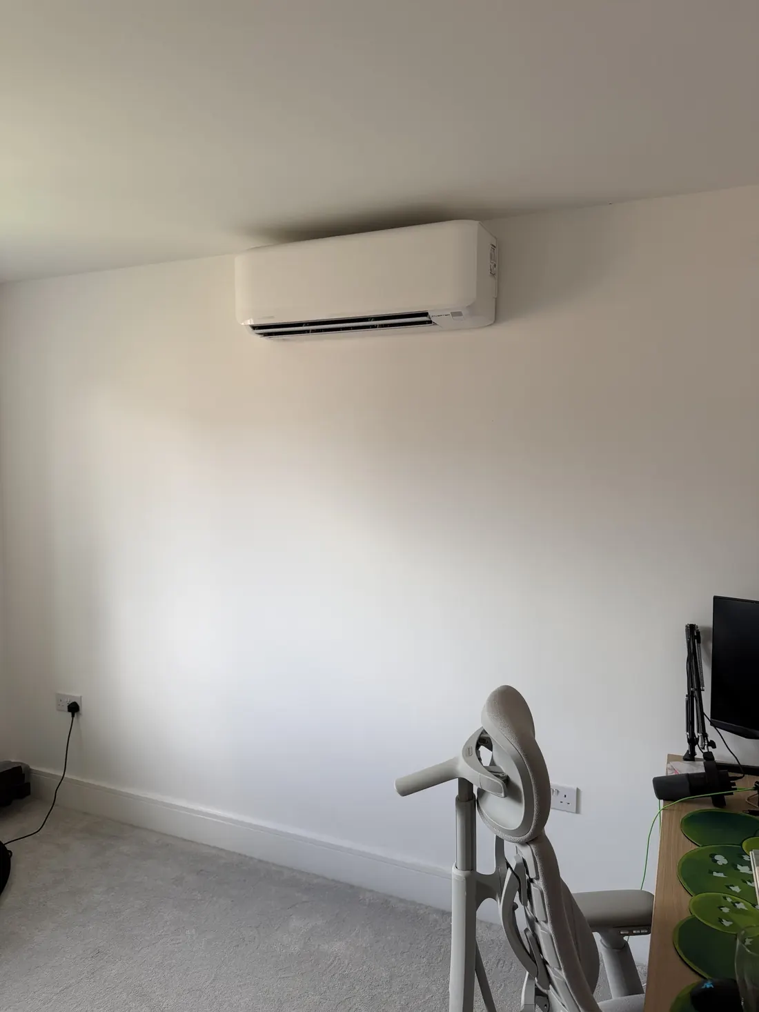 White Mitsubishi inverter wall unit in a home office