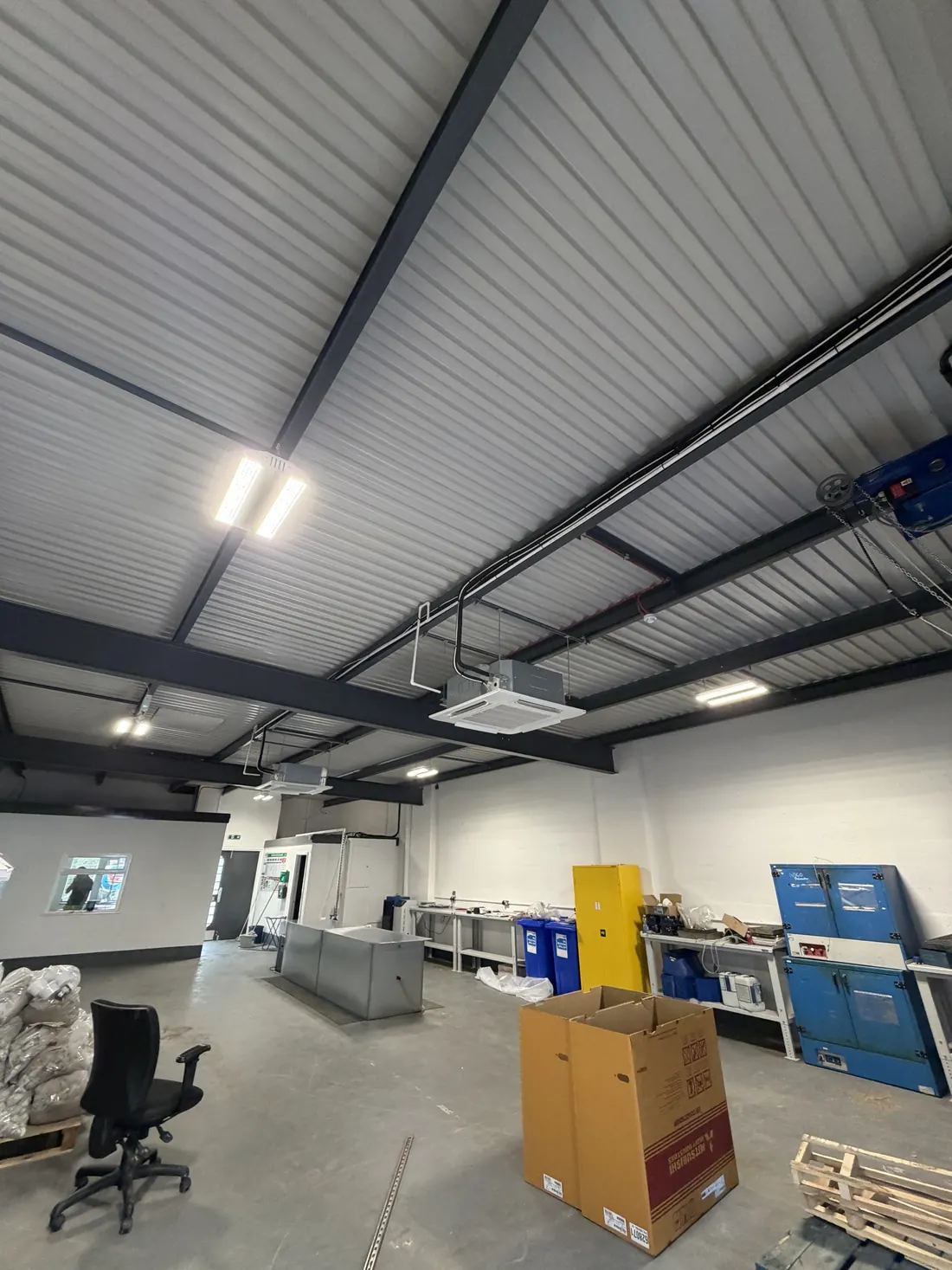 Two ceiling cassettes suspended from the steel in a new workshop