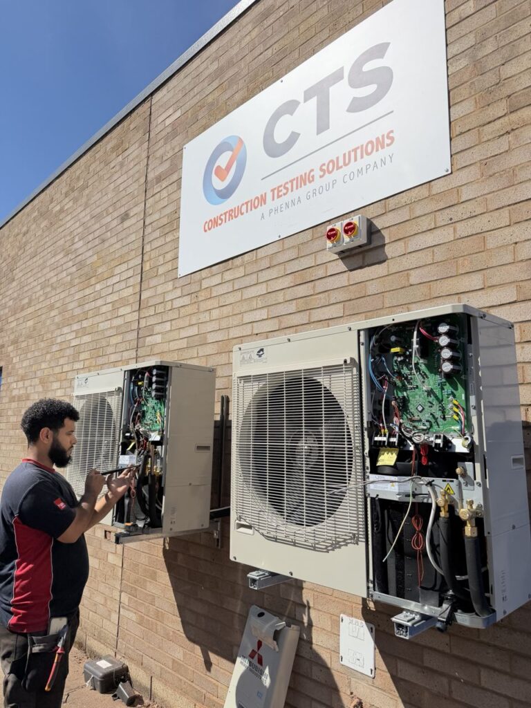 An Optimal engineer commissioning the wall-mounted outdoor units at CTS