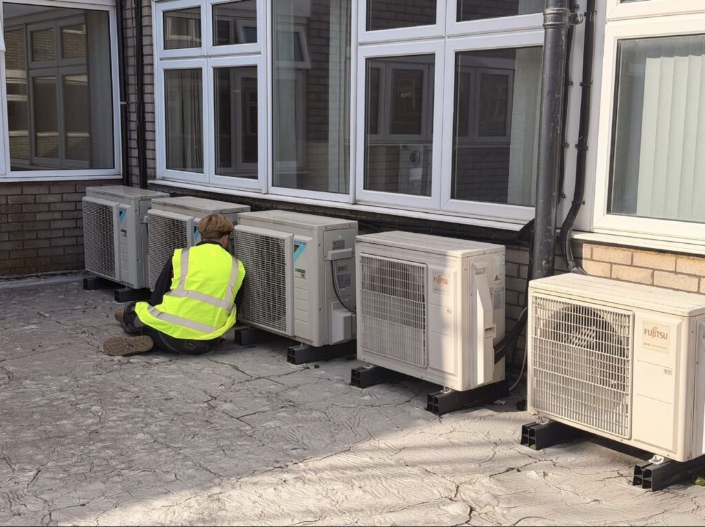 An Optimal engineer servicing a row of outdoor units