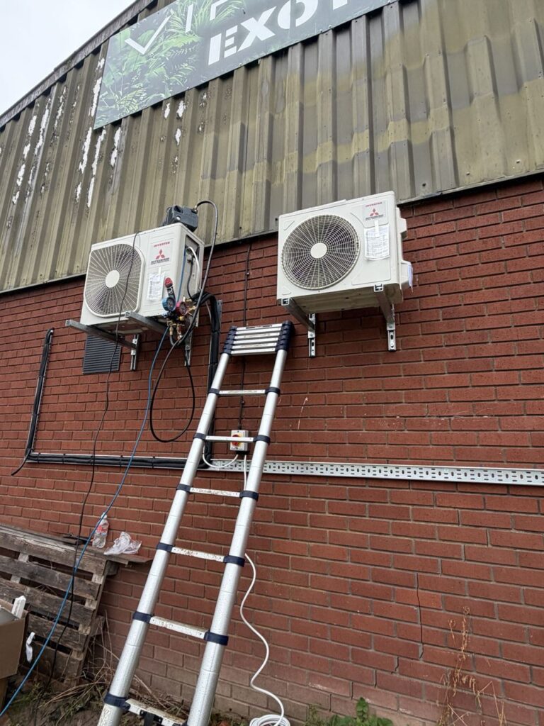 Two MHI Premium outdoor units on galvanised brackets with insulated pipework on cable tray