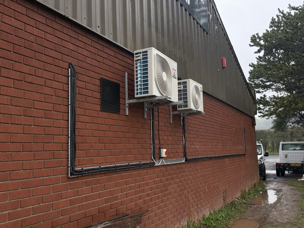 Outdoor units and tidy pipework on the brick elevation