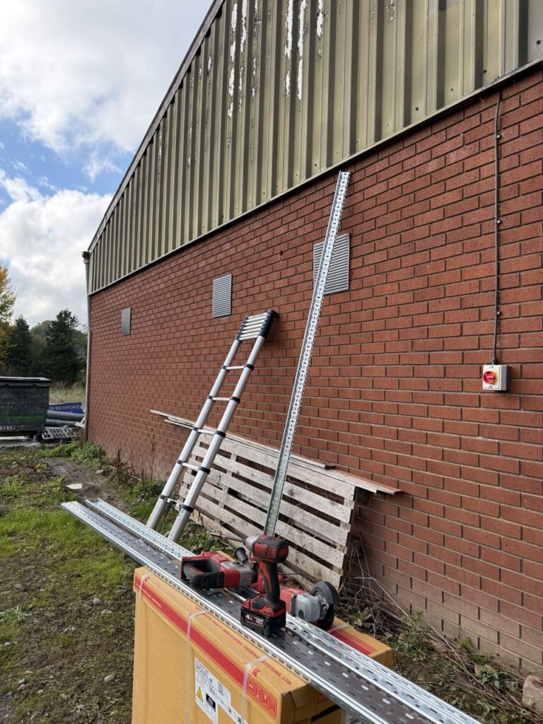 Cable tray and strut fixed to the brick wall before the pipework went in