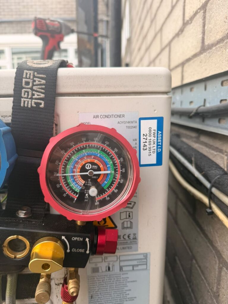 Commissioning the outdoor units with gauges and a vacuum pump